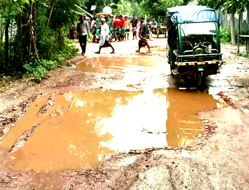 "Severely damaged roads in Barguna's six upazilas, Many roads have large potholes filled with water, making travel hazardous for local residents. Despite urgent calls for repairs, funding shortages are delaying necessary maintenance." Photo: V7N